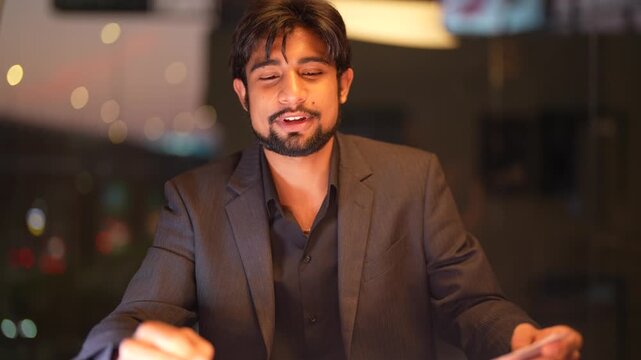 Competent South Asian tech specialist facilitating global digital transitions featuring a panoramic urban skyline at dusk displaying assertive leadership and expertise.