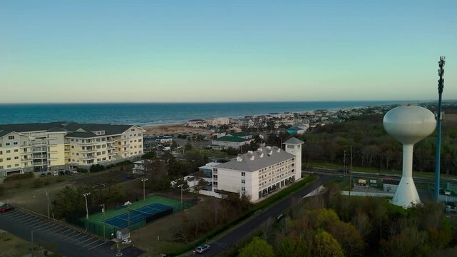 Aerial view of water tower and coastal resort at sunset in Sandbridge Virginia Beach