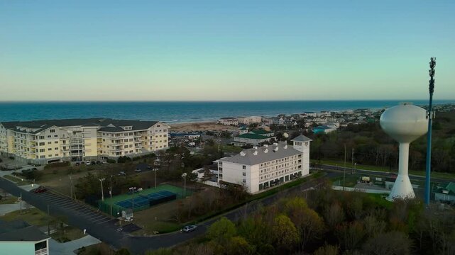 Aerial view of water tower and coastal resort at sunset in Sandbridge Virginia Beach