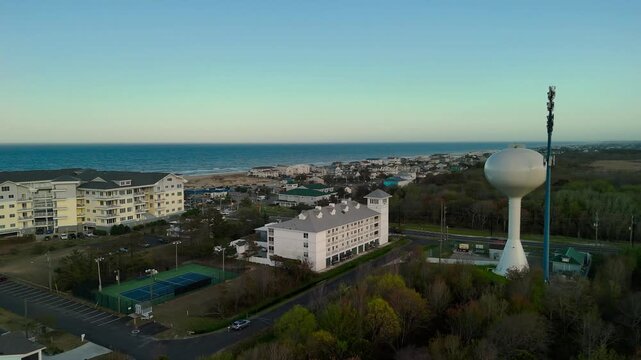Aerial view of water tower and coastal resort at sunset in Sandbridge Virginia Beach