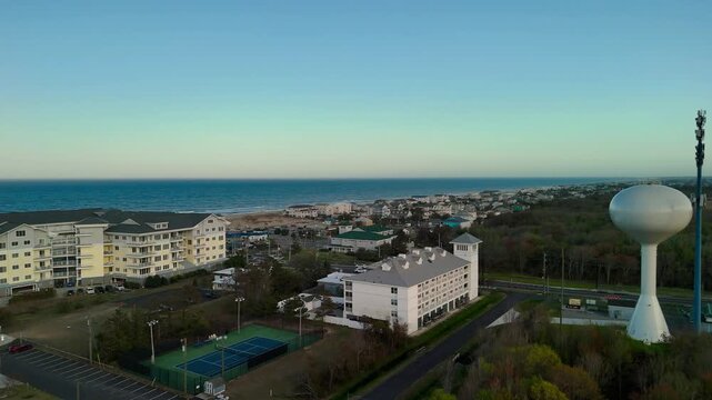 Aerial view of water tower and coastal resort at sunset in Sandbridge Virginia Beach
