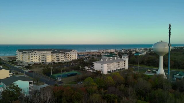 Aerial view of water tower and coastal resort at sunset in Sandbridge Virginia Beach