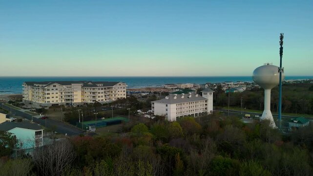 Aerial view of water tower and coastal resort at sunset in Sandbridge Virginia Beach