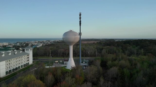 Aerial view of water tower and coastal resort at sunset in Sandbridge Virginia Beach
