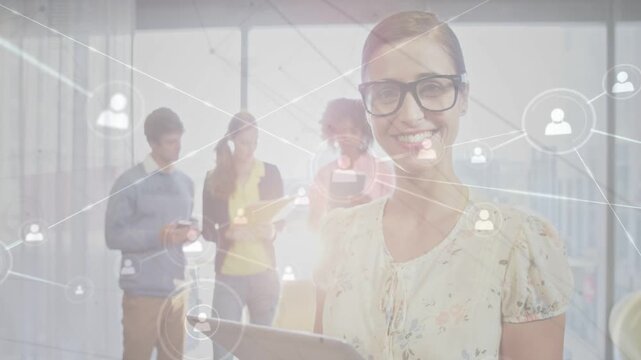 Woman tapping tablet and smiling, sharing network icons across team devices for business