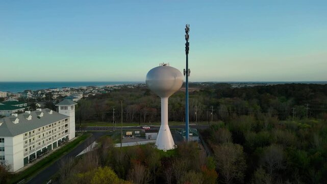 Aerial view of water tower and coastal resort at sunset in Sandbridge Virginia Beach