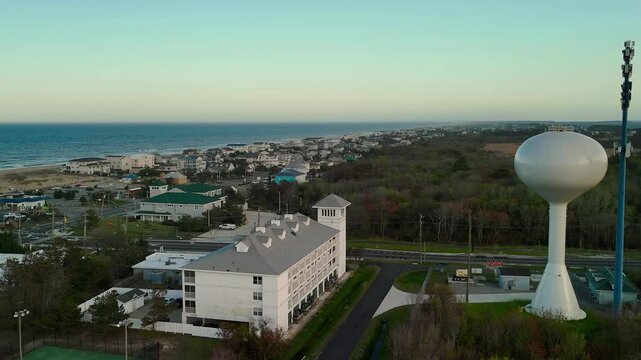 Aerial view of water tower and coastal resort at sunset in Sandbridge Virginia Beach