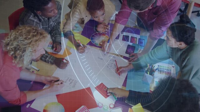 Designers sketching and passing swatches after color wheel prompt, refining palette under overlay