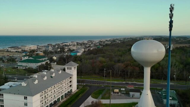 Aerial view of water tower and coastal resort at sunset in Sandbridge Virginia Beach