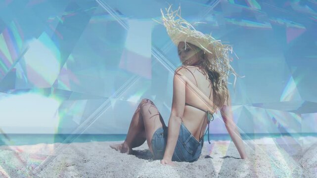 Woman modeling on sand, shifting, glancing as breeze lifting hair, prism overlay sweeping sunhat