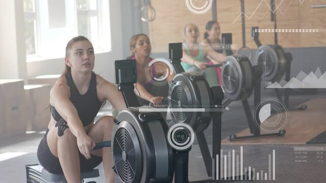Lead woman gripping erg and driving crew mirroring rowing while gym HUD over screen tracking power