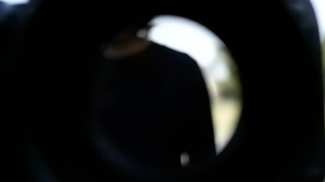 Man viewed through a peephole lens.