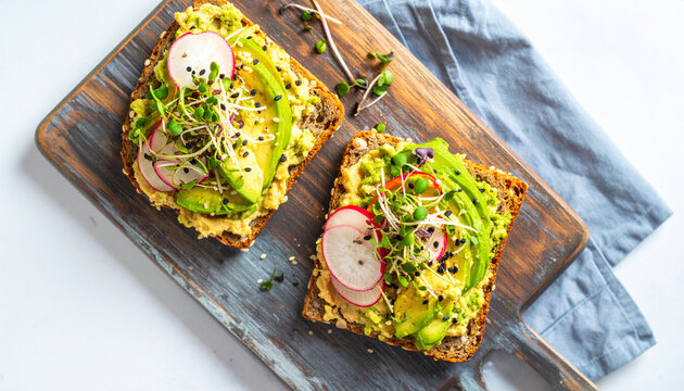 Nutritious and Visually Appealing Avocado Toast with Fresh Radish Slices and Microgreens on a Rustic Wooden Board