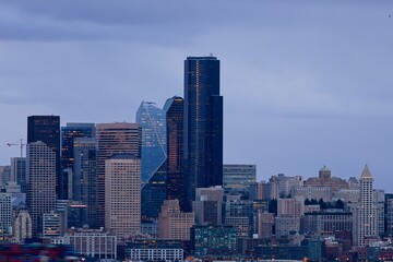 Fototapeta premium The skyline of Seattle glows above the chilly waters of the Puget Sound