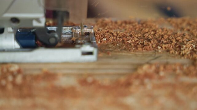 Closeup jigsaw cutting through plank, sawdust flying over workbench while blade and guide deliver precise wood removal, dynamic workshop scene with chips and shavings piling around tool, highlighting
