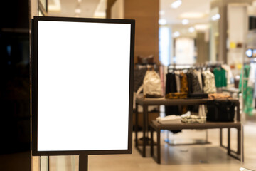 Blank illuminated sign board at modern fashion retail store entrance