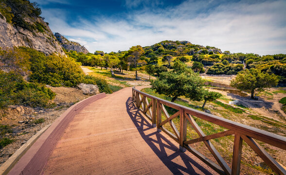 Sunny summer view of West Court of Heraion of Perachora  with wooden tourist walkway. Adorable  morning scene of outskirts of Limni Vouliagmenis town, Greece, Europe. Traveling concept background.