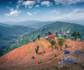 Wonderful summer view of colorful valley nestled in the heart of Nepal’s mountains. Picturesque evening scene of terraced fields cascade down, Nepal, Asia. Beauty of countryside concept background.