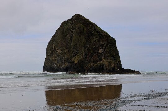Haystack Rock rises above the chilly Pacific Ocean near Cannon Beach, Oregon