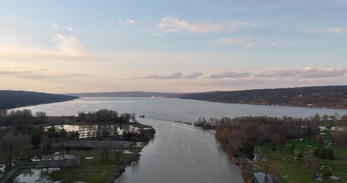 Stunning timelapse aerial video the south end of Cayuga Lake, in Ithaca, NY, at sunset with cloud movement.
