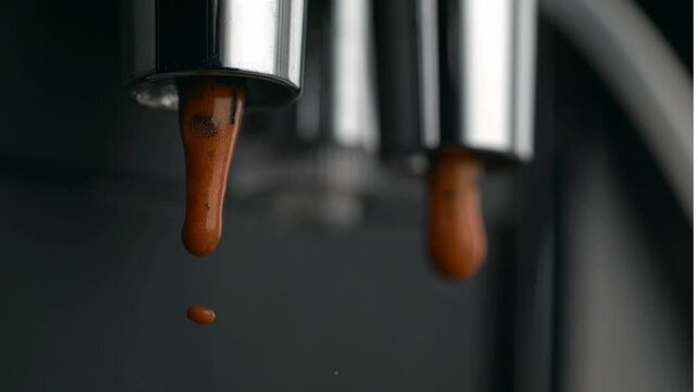Chocolate syrup pouring from dispensers.
