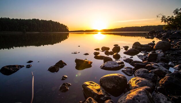 Sunset over lake with rocks and reflections