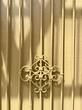 Striped shadow pattern on wall from fire escape with strong geometric lines and minimal background