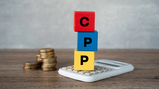 CPP Canada Pension Plan acronym on colorful wooden blocks with white calculator and stacked coins