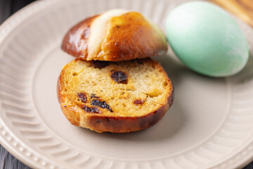 Delicious Easter Hot Cross Buns on wooden Basket. Sweet Bread. Holiday Food