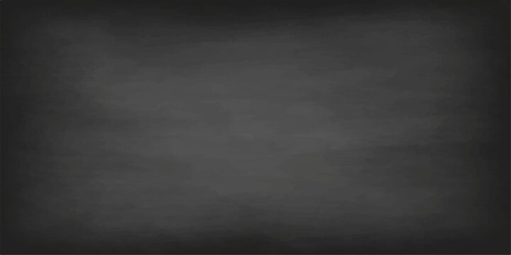 Vintage dark gray chalkboard background with a dirty grunge texture and blank old blackboard surface design for a weathered wall backdrop