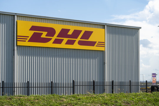 DHL express courier logistics sign and logo on warehouse distribution centre, Melbourne Australia. It is an international express courier, freight and logistics company