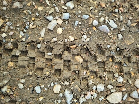  tire tracks on rocky mountain soil 