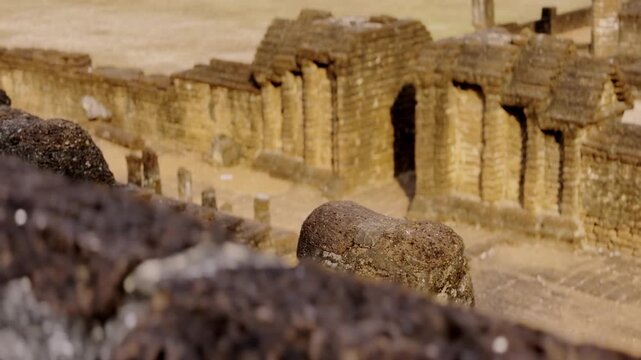 Elevated wide view of ancient vihara ruins and laterite pillars at Wat Chang Lom.