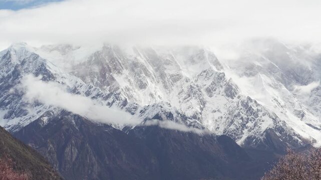 Landscape of Namcha Barwa, also known as the Killer Mountain, is one of the most majestic peaks in the world. Beautiful snow capped mountains in white clouds, 4k time lapse footage travel concept.