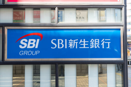 TOSHIMA, TOKYO, JAPAN - APRIL 3, 2026: The storefront facade and horizontal branding sign of an SBI Shinsei Bank branch in Toshima, Tokyo.