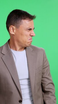 Puzzled businessman looking confused on green screen