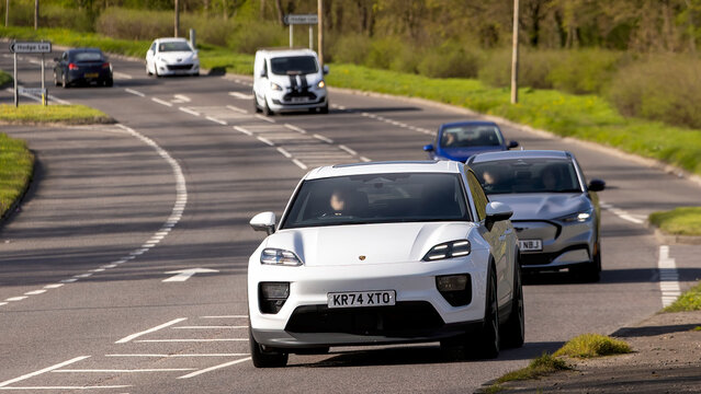 Milton Keynes,Bucks,UK - Mar 26th 2026:   2025 white Porsche Macan 4 electric car driving on a British road