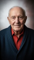 Obraz premium Senior elderly man looking at camera with a dignified expression for longevity and heritage features, portrait of a centenarian wearing a blue cardigan and red shirt