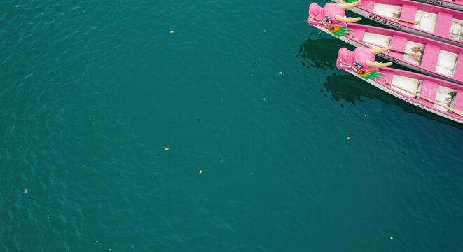 Pink Dragon Boat Prows Floating on Turquoise Water with Copy Space for Travel and Cultural Festival Background during Traditional Race Celebration