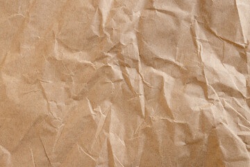 Obraz premium Top view of crumpled brown kraft paper texture background,Macro,A high-resolution, detailed texture of wrinkled and crumpled brown recycled paper, perfect for vintage backgrounds, eco-friendly concept