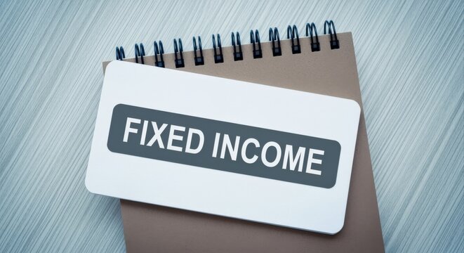 Close-up overhead view of a notebook with 'FIXED INCOME' written on a label, symbolizing financial investment and wealth management.