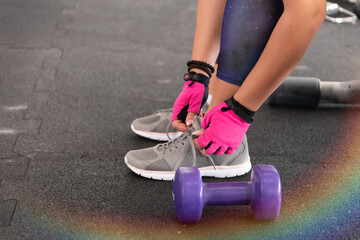 Woman Tying Sports Shoes in Gym – Fitness Preparation and Workout Routine