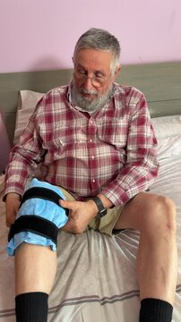 Person removing the ice pack from the knee after treatment