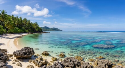 Naklejka premium Pristine tropical island beach with coral reef and turquoise seawater.