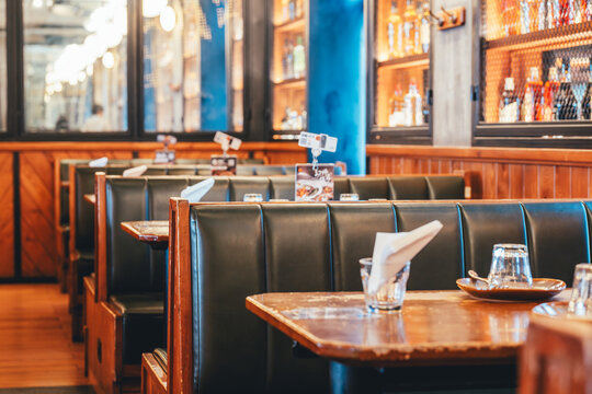 Retro-style restaurant booth seating with wooden tables and leather upholstery