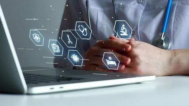 Healthcare professional uses computer to access medical information and technology at a desk during work hours.