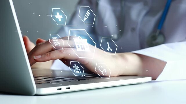 Medical professional using laptop with health icons on screen in a office setting during daytime.