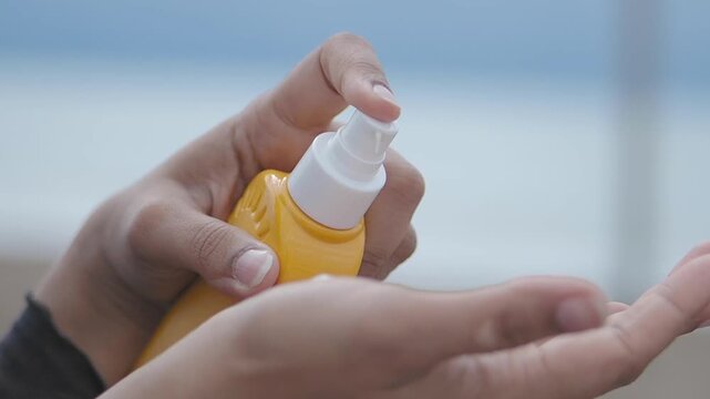 Applying sunscreen in sunny weather while at the beach