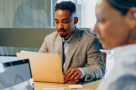 Businessperson intensely examining digital dashboards thoughtfully