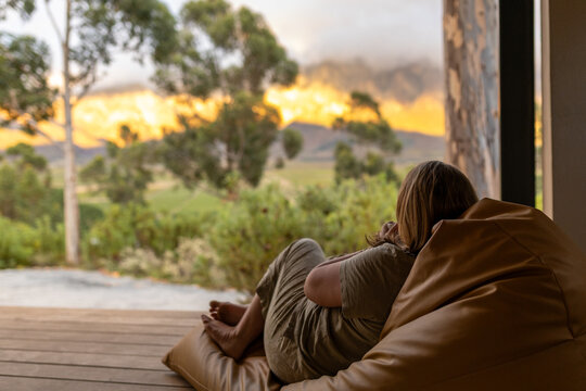 Women drinking coffee and admiring an outdoor view at sunrise